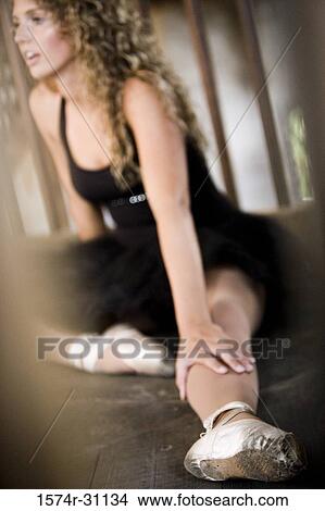 Ballet dancer sitting on hardwood floor View Large Photo Image Picture - Ballet dancer sitting on hardwood floor. Fotosearch