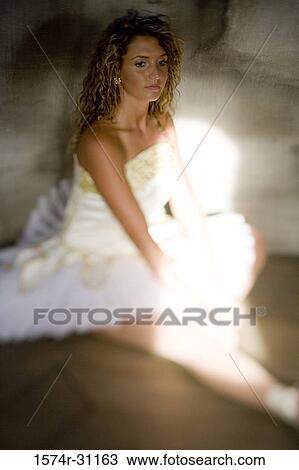 Ballet dancer sitting on hardwood floor and looking away View Large Photo Image Stock Image - Ballet dancer sitting on hardwood floor and looking away. Fotosearch