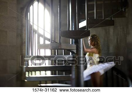 Ballet dancer standing by spiral wooden steps View Large Photo Image Stock Image - Ballet dancer standing by spiral wooden steps. Fotosearch