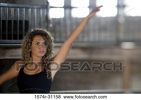 Ballet dancer standing with hand raised View Large Photo Image Stock Photo - Ballet dancer standing with hand raised. Fotosearch