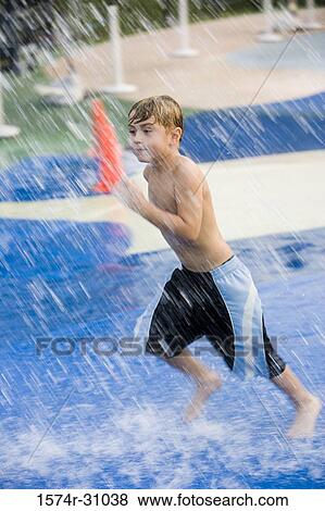 Bare chested boy running under a shower View Large Photo Image Stock Photo - Bare chested boy running under a shower. Fotosearch