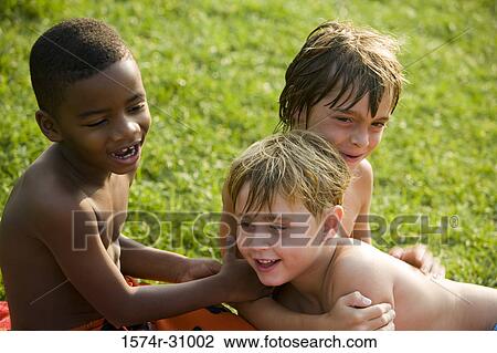 Bare chested boys playing on grass View Large Photo Image Stock Image - Bare chested boys playing on grass. Fotosearch