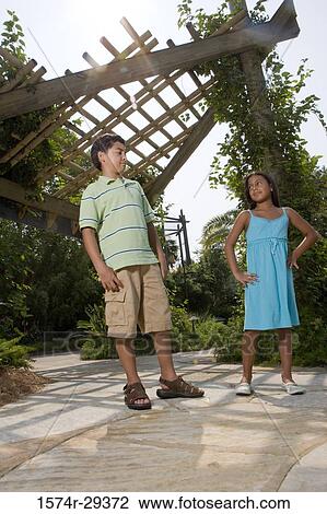 Boy and girl standing together View Large Photo Image Stock Image - Boy and girl standing together. Fotosearch