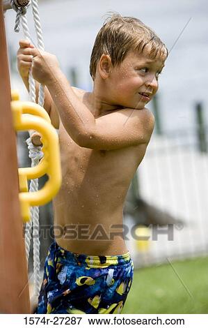 Boy climbing rope ladder and looking over shoulder View Large Photo Image Stock Photo - Boy climbing rope ladder and looking over shoulder. Fotosearch