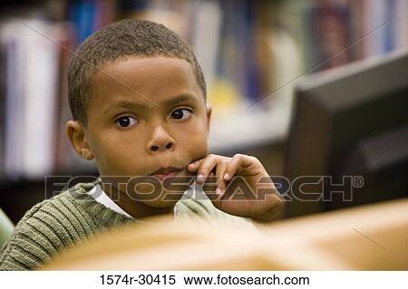 Boy in the library looking away View Large Photo Image Stock Photography - Boy in the library looking away. Fotosearch