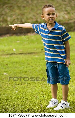 Boy playing a football at park View Large Photo Image Stock Photo - Boy playing a football at park. Fotosearch