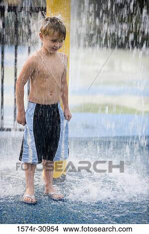 Boy standing under a shower View Large Photo Image Picture - Boy standing under a shower. Fotosearch