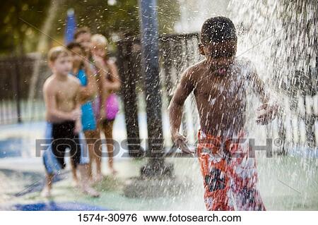 Stock Photograph - Boy standing under a shower. Fotosearch