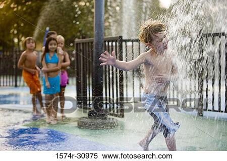 Boy standing under a shower View Large Photo Image Stock Photography - Boy standing under a shower. Fotosearch