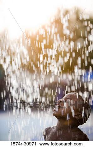 Boy standing under a shower with mouth open View Large Photo Image Stock Image - Boy standing under a shower with mouth open. Fotosearch