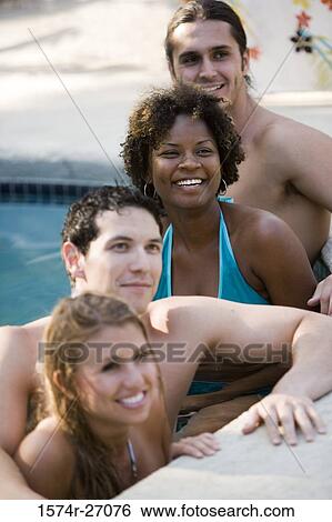 Boyfriends with their girlfriends smiling in swimming pool View Large Photo Image Stock Photograph - Boyfriends with their girlfriends smiling in swimming pool. Fotosearch