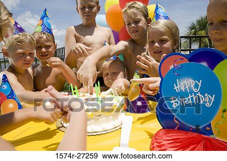 Stock Photo - Boys and girls celebrating birthday party. Fotosearch
