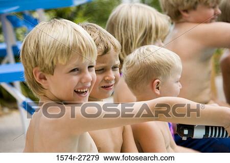 Stock Photo - Boys and girls sitting together and smiling. Fotosearch