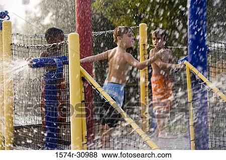 Boys playing in a water park View Large Photo Image Stock Photo - Boys playing in a water park. Fotosearch