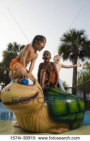 Boys sitting together on a tortoise sculpture View Large Photo Image Stock Photography - Boys sitting together on a tortoise sculpture. Fotosearch