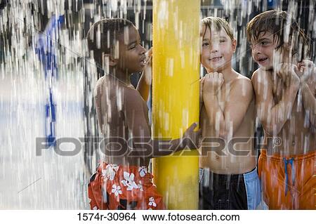 Boys standing together under a shower View Large Photo Image Picture - Boys standing together under a shower. Fotosearch