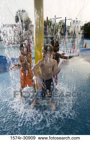 Boys standing under a shower View Large Photo Image Stock Photo - Boys standing under a shower. Fotosearch