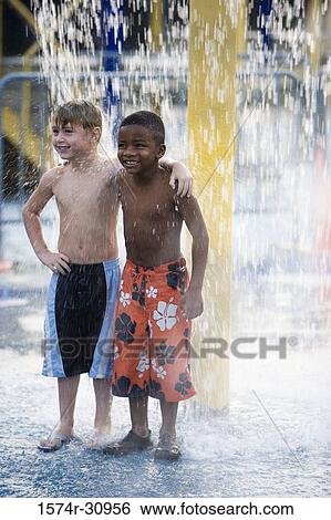 Boys standing under a shower View Large Photo Image Stock Photograph - Boys standing under a shower. Fotosearch
