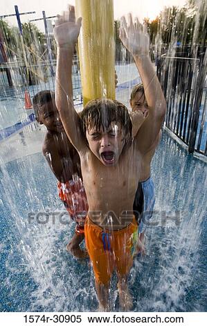 Boys standing under a shower View Large Photo Image Stock Photography - Boys standing under a shower. Fotosearch