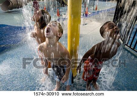 Boys standing under a shower with mouth open View Large Photo Image Stock Image - Boys standing under a shower with mouth open. Fotosearch