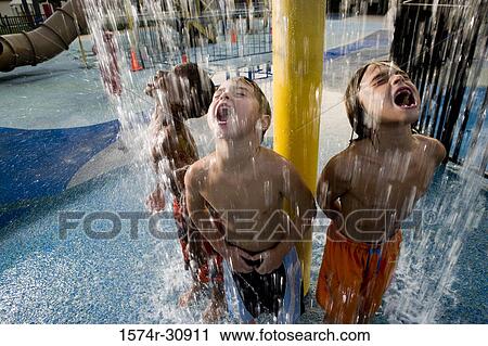 Boys standing under a shower with mouth open View Large Photo Image Stock Image - Boys standing under a shower with mouth open. Fotosearch