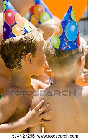Stock Photograph - Boys wearing party hat. Fotosearch