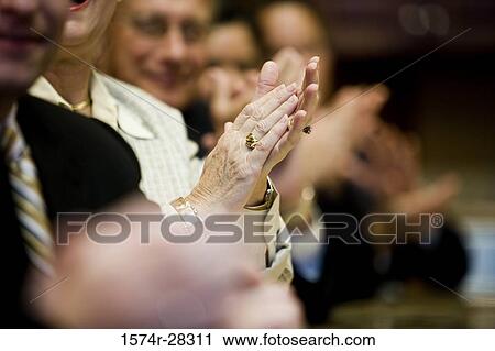 Stock Image - Business people applauding in a meeting at office. Fotosearch