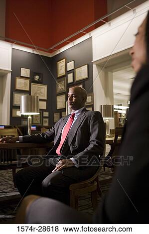 Stock Photo - Business People conversing in an office. Fotosearch