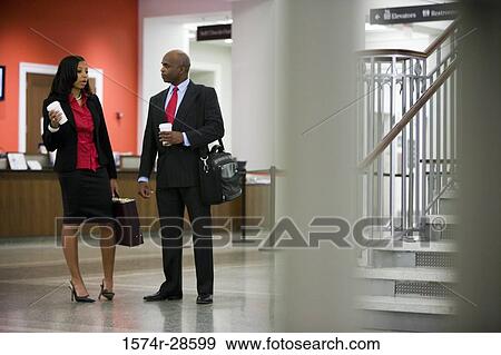 Stock Photo - Business People conversing to each other. Fotosearch