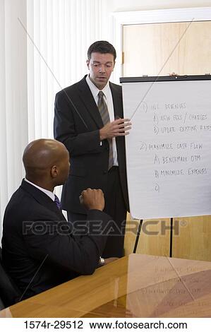 Business people discussing in an office View Large Photo Image Stock Image - Business people discussing in an office. Fotosearch