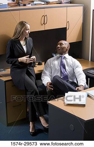 Business people discussing in an office View Large Photo Image Stock Image - Business people discussing in an office. Fotosearch