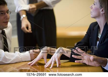 Business people discussing in an office View Large Photo Image Stock Image - Business people discussing in an office. Fotosearch