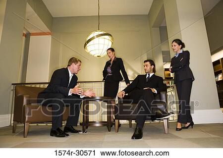 Business people discussing in an office View Large Photo Image Stock Image - Business people discussing in an office. Fotosearch