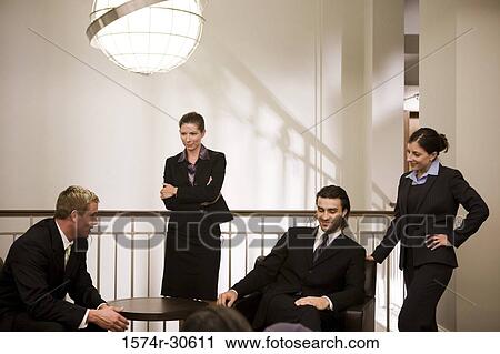 Stock Image - Business people discussing in an office. Fotosearch