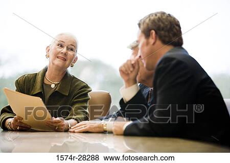 Stock Photo - Business people discussing in an office. Fotosearch