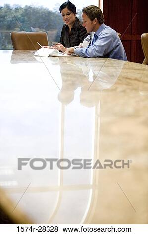 Business people discussing in an office View Large Photo Image Stock Photo - Business people discussing in an office. Fotosearch