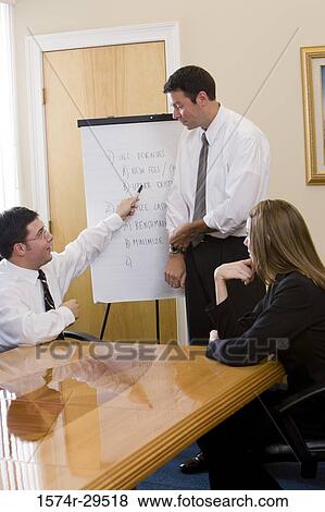 Business people discussing in an office View Large Photo Image Stock Photo - Business people discussing in an office. Fotosearch