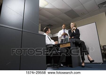 Business people discussing in an office View Large Photo Image Stock Photo - Business people discussing in an office. Fotosearch
