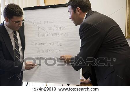 Business people discussing in an office View Large Photo Image Stock Photo - Business people discussing in an office. Fotosearch