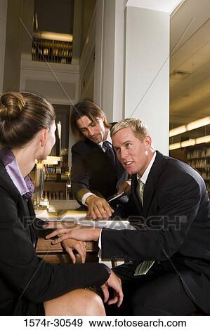 Business people discussing in an office View Large Photo Image Stock Photo - Business people discussing in an office. Fotosearch
