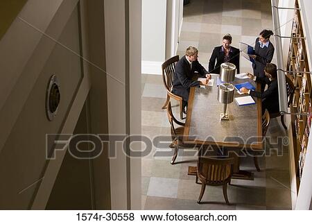 Stock Photo - Business people discussing in an office. Fotosearch