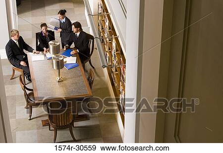 Stock Photo - Business people discussing in an office. Fotosearch