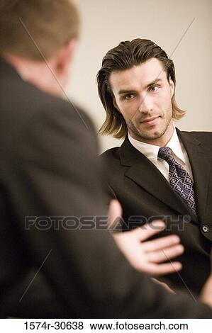 Business people discussing in an office View Large Photo Image Stock Photo - Business people discussing in an office. Fotosearch