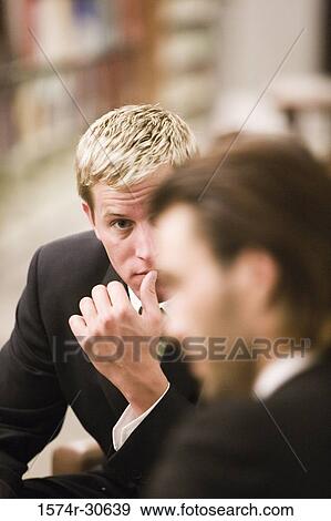 Business people discussing in an office View Large Photo Image Stock Photo - Business people discussing in an office. Fotosearch