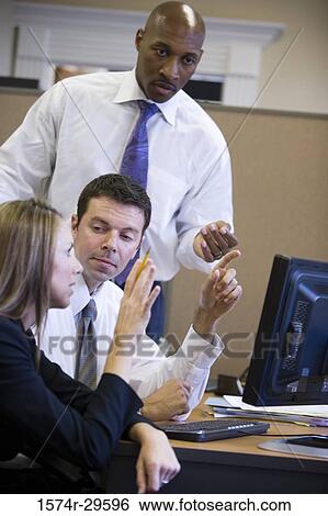 Business people discussing in an office View Large Photo Image Stock Photograph - Business people discussing in an office. Fotosearch