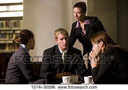 Business people discussing in an office View Large Photo Image Stock Photograph - Business people discussing in an office. Fotosearch