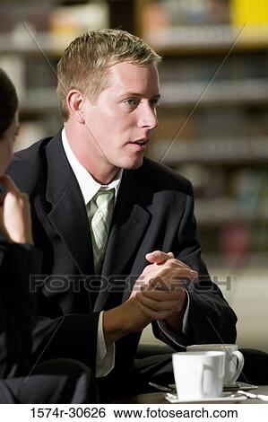 Business people discussing in an office View Large Photo Image Stock Photograph - Business people discussing in an office. Fotosearch