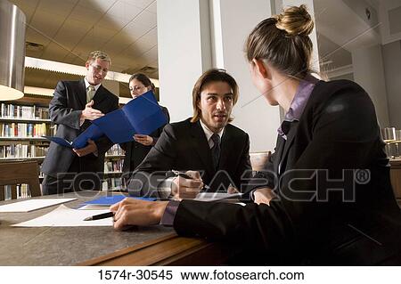 Stock Photography - Business people discussing in an office. Fotosearch