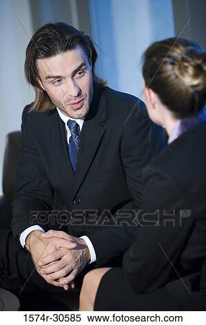 Stock Photography - Business people discussing in an office. Fotosearch