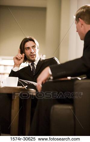 Business people discussing in an office View Large Photo Image Stock Photography - Business people discussing in an office. Fotosearch